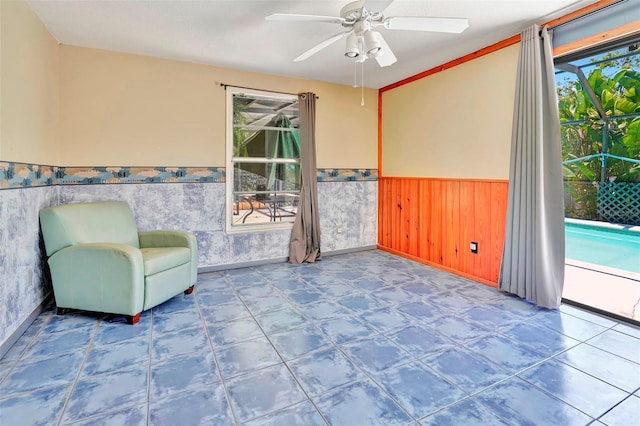 unfurnished room featuring tile patterned floors and ceiling fan