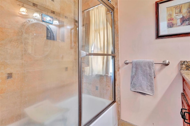 bathroom with vanity and bath / shower combo with glass door