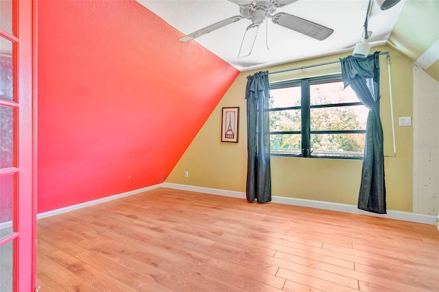 bonus room featuring ceiling fan, vaulted ceiling, and light wood-type flooring