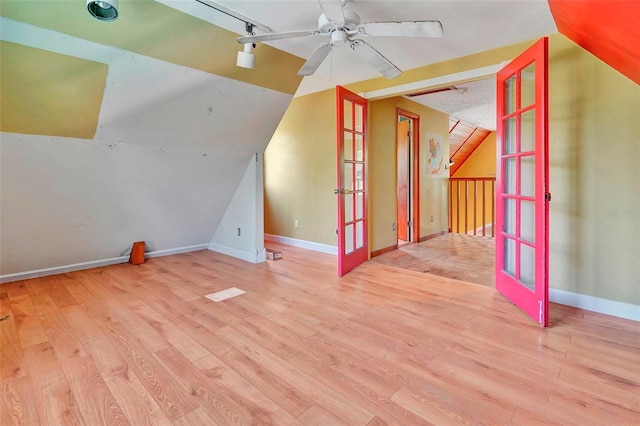 bonus room featuring lofted ceiling, ceiling fan, light wood-type flooring, and french doors