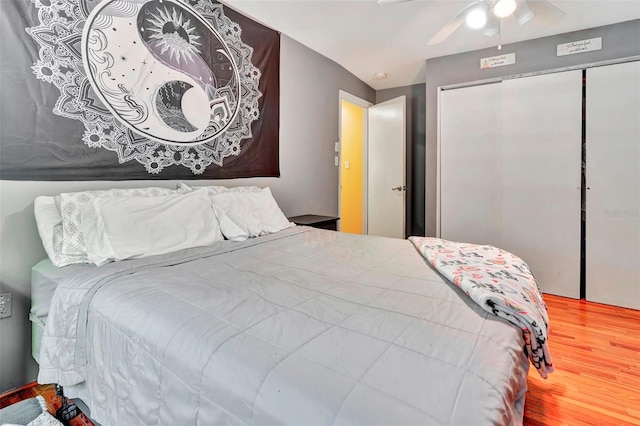 bedroom with ceiling fan, a closet, and hardwood / wood-style flooring