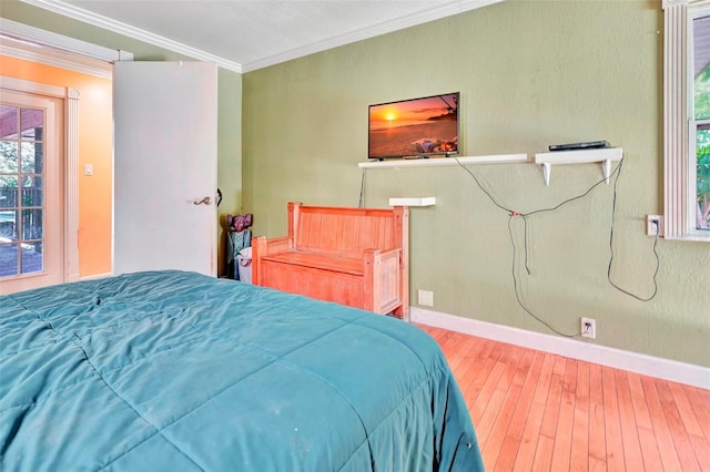 bedroom featuring wood-type flooring and ornamental molding