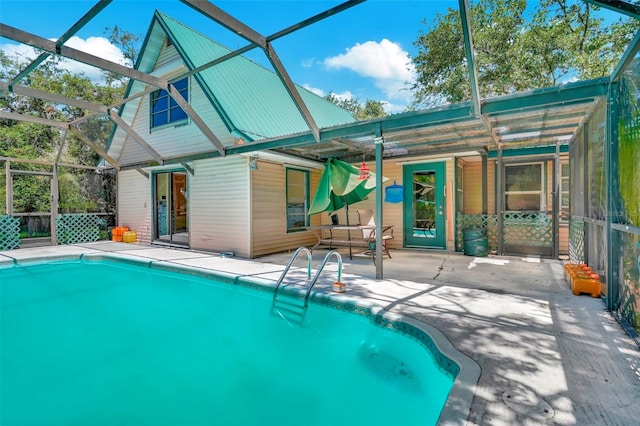 view of swimming pool with a lanai and a patio