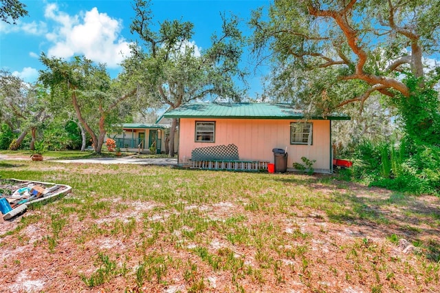 rear view of house with a yard