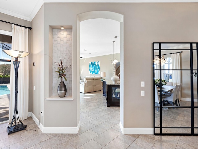 interior space featuring light tile patterned floors and crown molding