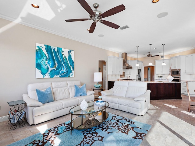 living room with crown molding, ceiling fan, and light tile patterned floors