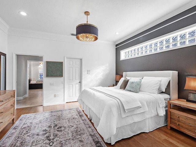 bedroom with light wood-type flooring and crown molding