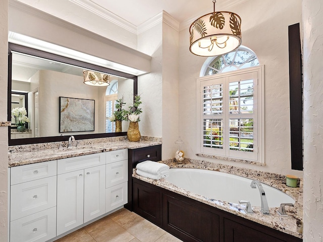 bathroom with a bath, vanity, a wealth of natural light, and crown molding