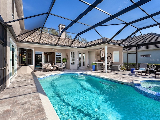 view of swimming pool with a lanai, ceiling fan, and a patio