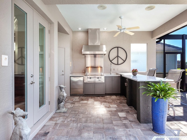 kitchen featuring wall chimney exhaust hood, refrigerator, kitchen peninsula, and french doors