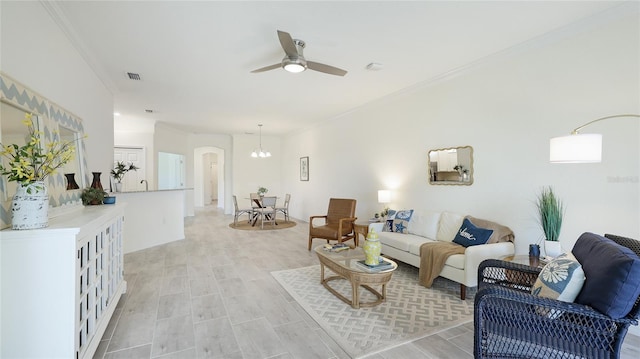 living room with ornamental molding and ceiling fan