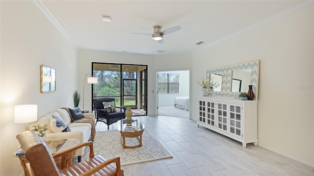 tiled living room featuring crown molding and ceiling fan