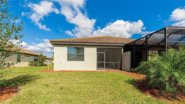 back of house featuring a yard and a lanai