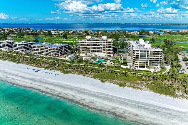 birds eye view of property with a beach view and a water view