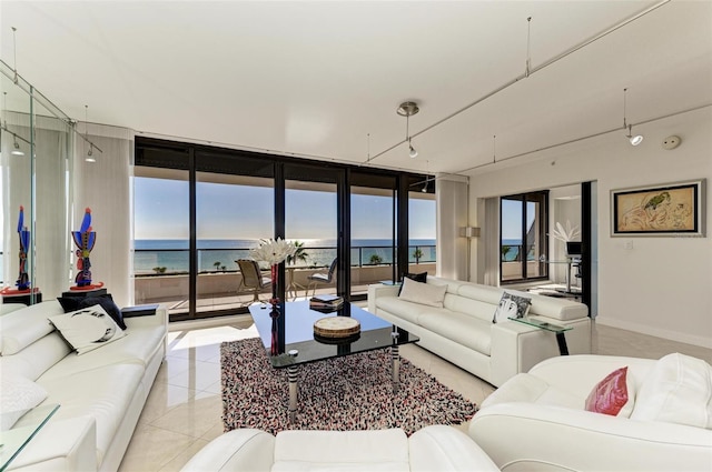 tiled living room with a water view and floor to ceiling windows