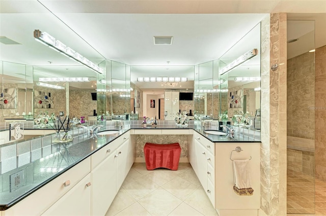 bathroom featuring tile patterned floors, vanity, and a shower