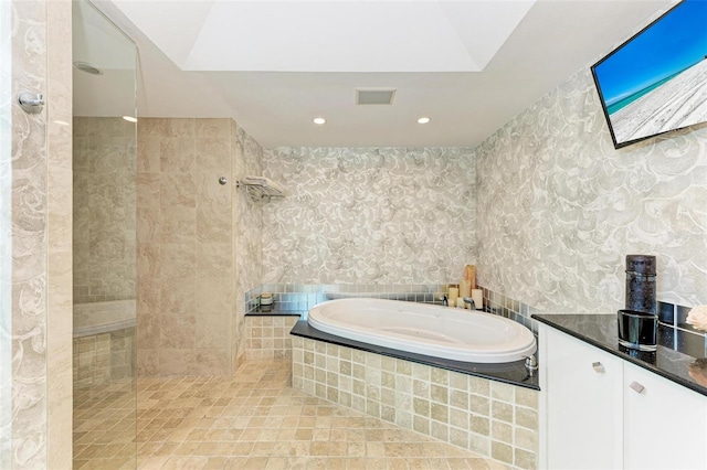 bathroom featuring separate shower and tub