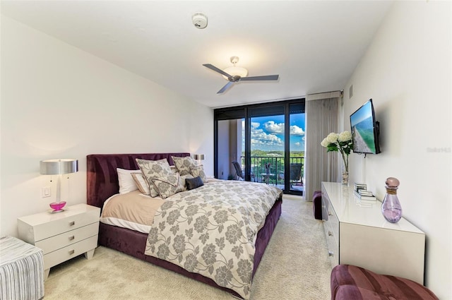 carpeted bedroom with ceiling fan, floor to ceiling windows, and access to exterior