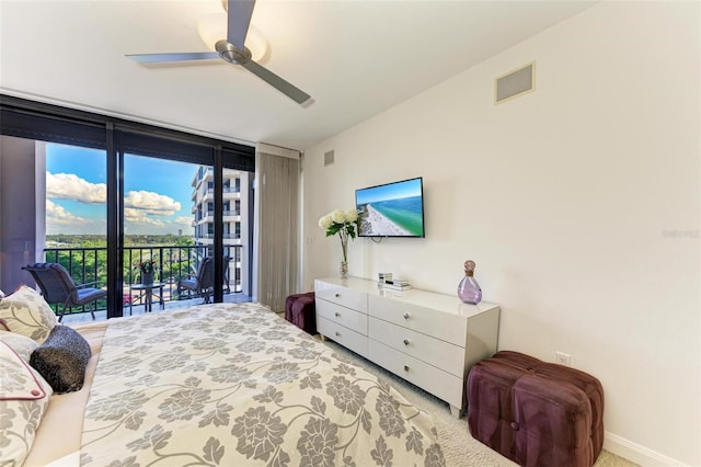 bedroom featuring light colored carpet, ceiling fan, access to exterior, and a wall of windows