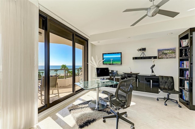 office space with ceiling fan, floor to ceiling windows, and light tile patterned flooring