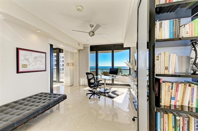 tiled office space with floor to ceiling windows and ceiling fan