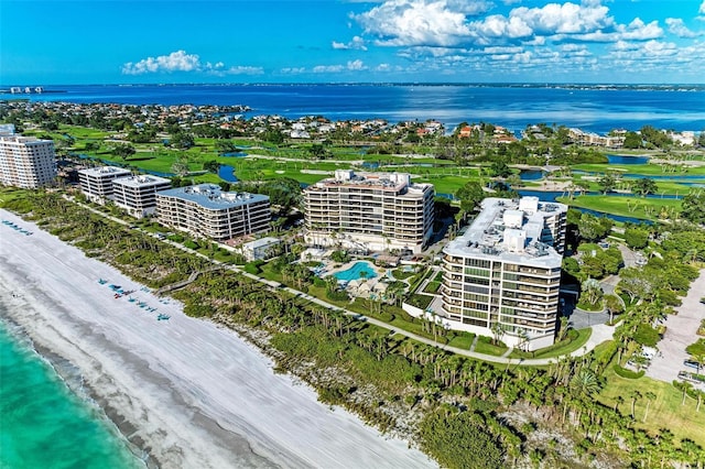 birds eye view of property with a water view and a view of the beach