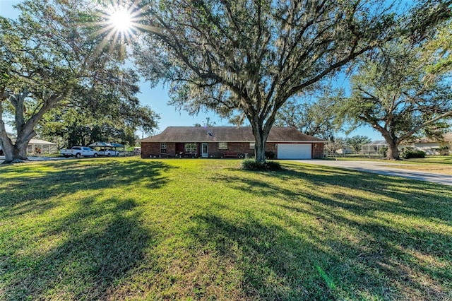 ranch-style home with a front yard and a garage