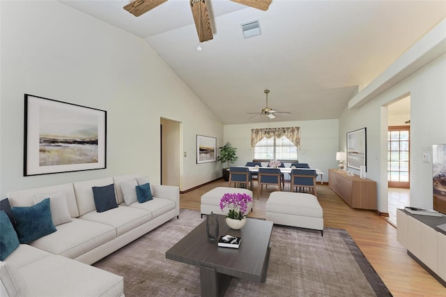 living room with light hardwood / wood-style flooring, ceiling fan, and lofted ceiling