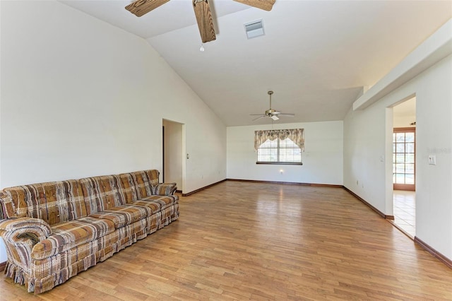 living room with ceiling fan, lofted ceiling, and light hardwood / wood-style flooring