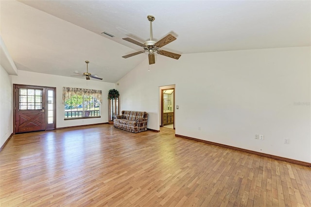 interior space featuring ceiling fan, vaulted ceiling, and light wood-type flooring