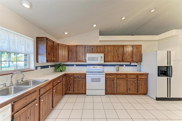 kitchen with white appliances, backsplash, sink, vaulted ceiling, and light tile patterned flooring