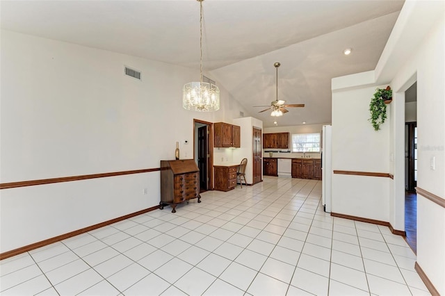 kitchen with ceiling fan with notable chandelier, light tile patterned floors, white appliances, and lofted ceiling