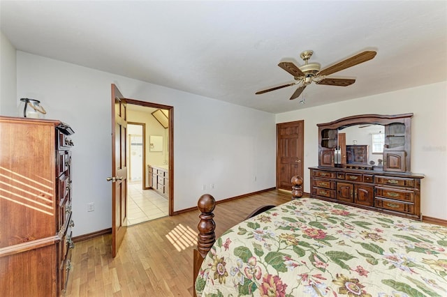 bedroom with ceiling fan, light wood-type flooring, and ensuite bathroom