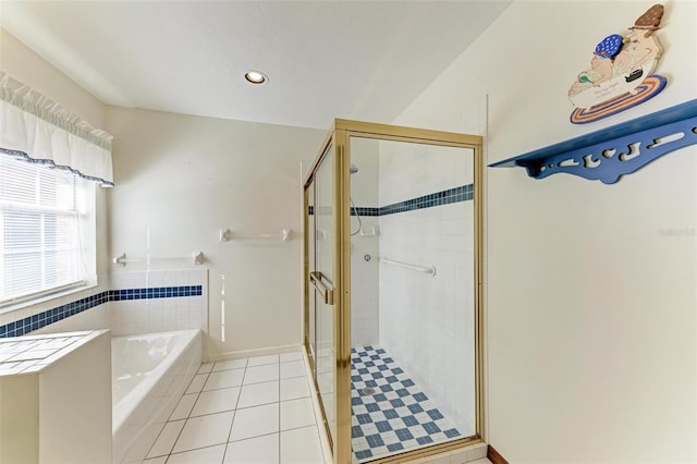 bathroom with tile patterned floors and shower with separate bathtub