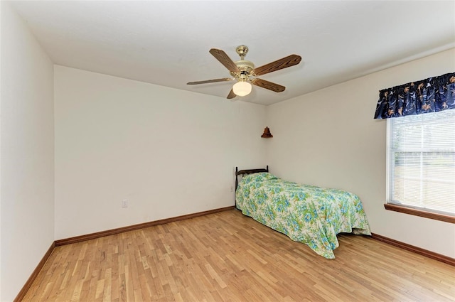 unfurnished bedroom with ceiling fan and hardwood / wood-style flooring