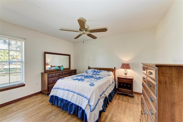 bedroom with light hardwood / wood-style flooring and ceiling fan