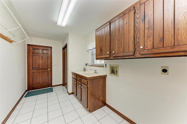 laundry room with electric dryer hookup, cabinets, sink, washer hookup, and light tile patterned floors