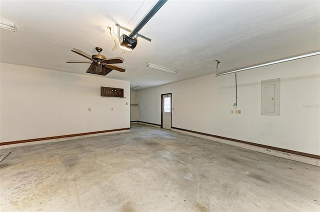 garage featuring electric panel, a garage door opener, and ceiling fan