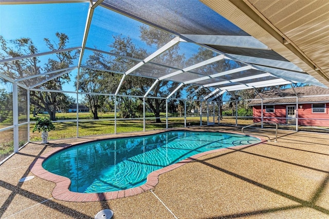 view of swimming pool with a patio area, a lanai, an outdoor structure, and a yard