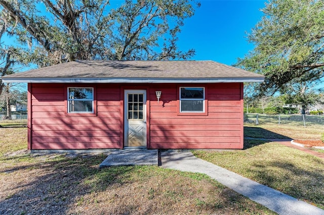 view of outbuilding with a yard