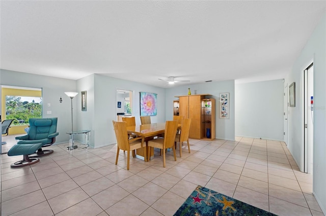 dining space featuring light tile patterned floors and ceiling fan