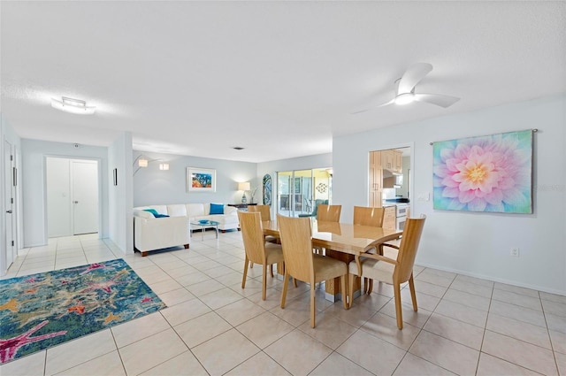 dining space featuring light tile patterned floors, ceiling fan, and a textured ceiling