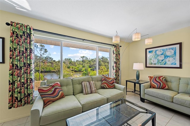 living room with a water view and light tile patterned floors