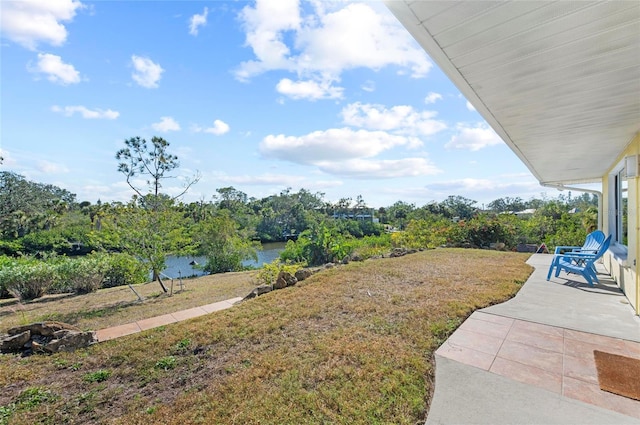 view of yard with a patio area and a water view