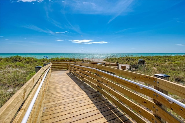 view of property's community with a beach view and a water view