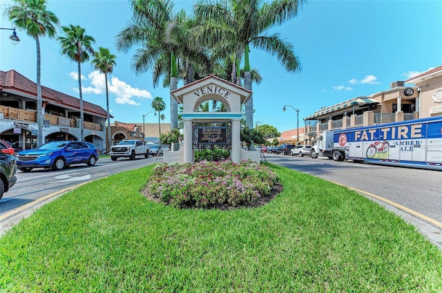 exterior space featuring street lights and curbs