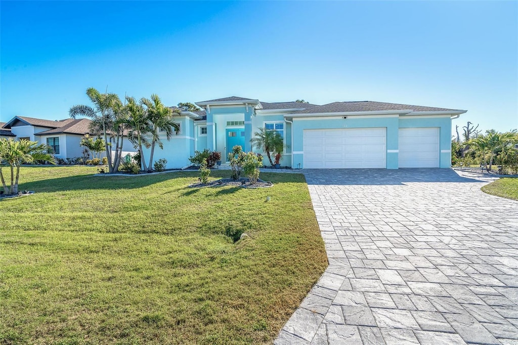 ranch-style home with a garage and a front lawn