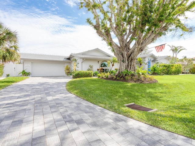 ranch-style house with a front yard and a garage