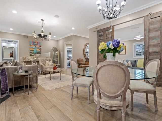 dining room featuring a notable chandelier, crown molding, and light hardwood / wood-style flooring