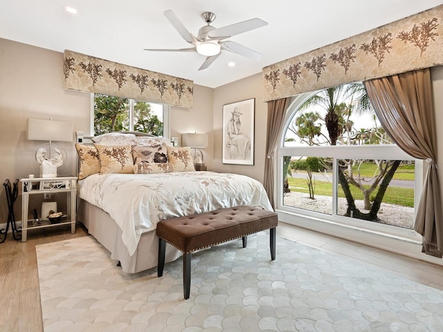 bedroom featuring ceiling fan and light hardwood / wood-style flooring